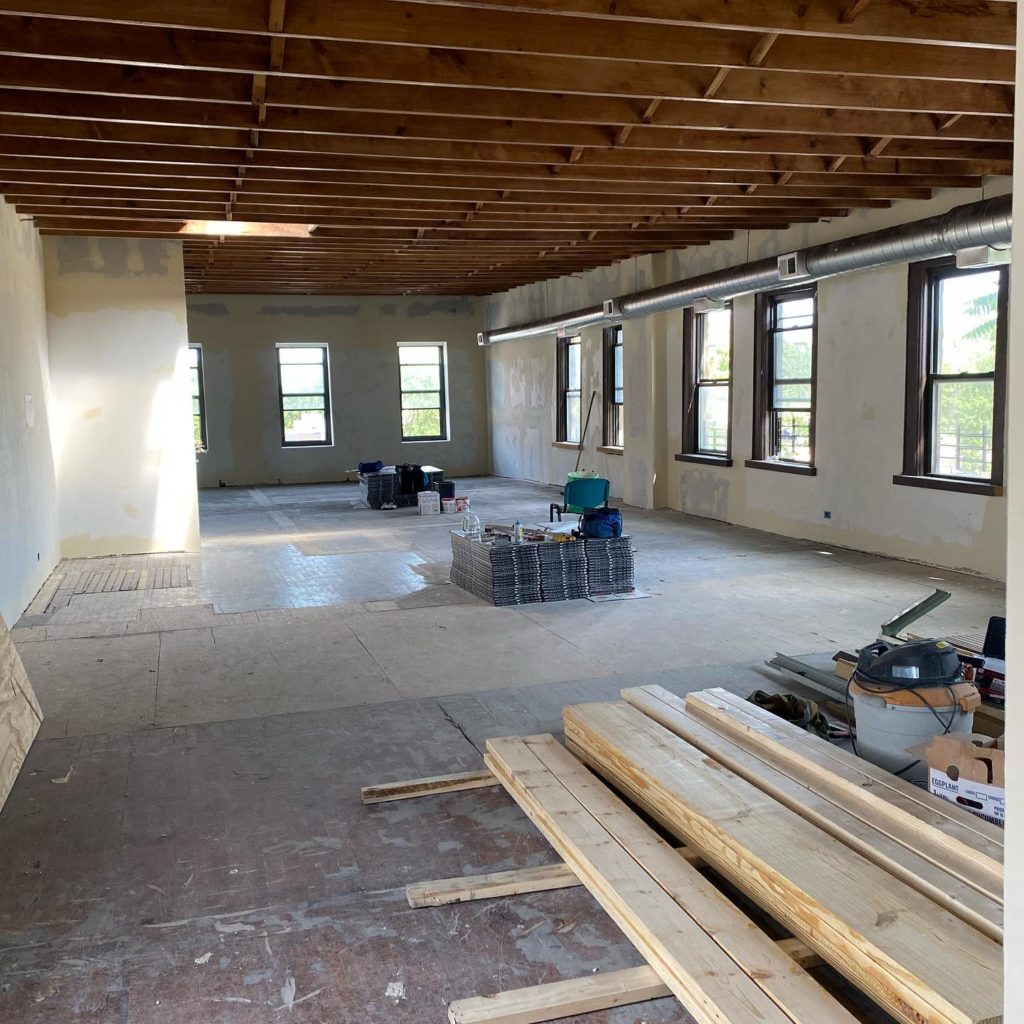 The inside of PFP's new home, with beautiful wooden ceilings and renovation supplies along the floor.