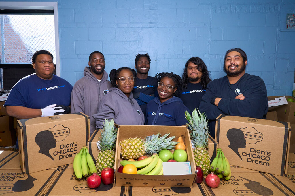 Dion's Chicago Dream staff smile with their fresh produce boxes.